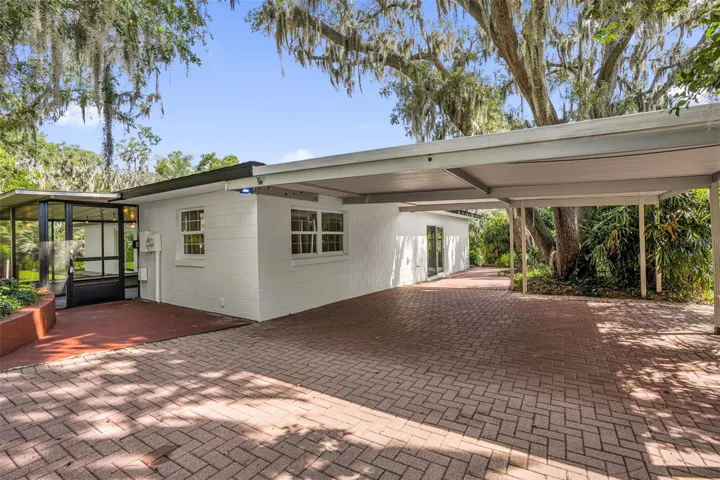 Covered carport with ample parking space, providing convenience for multiple vehicles and easy everyday access.