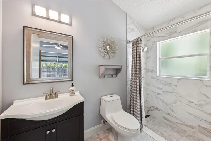 Primary en-suite bathroom with updated shower & vanity