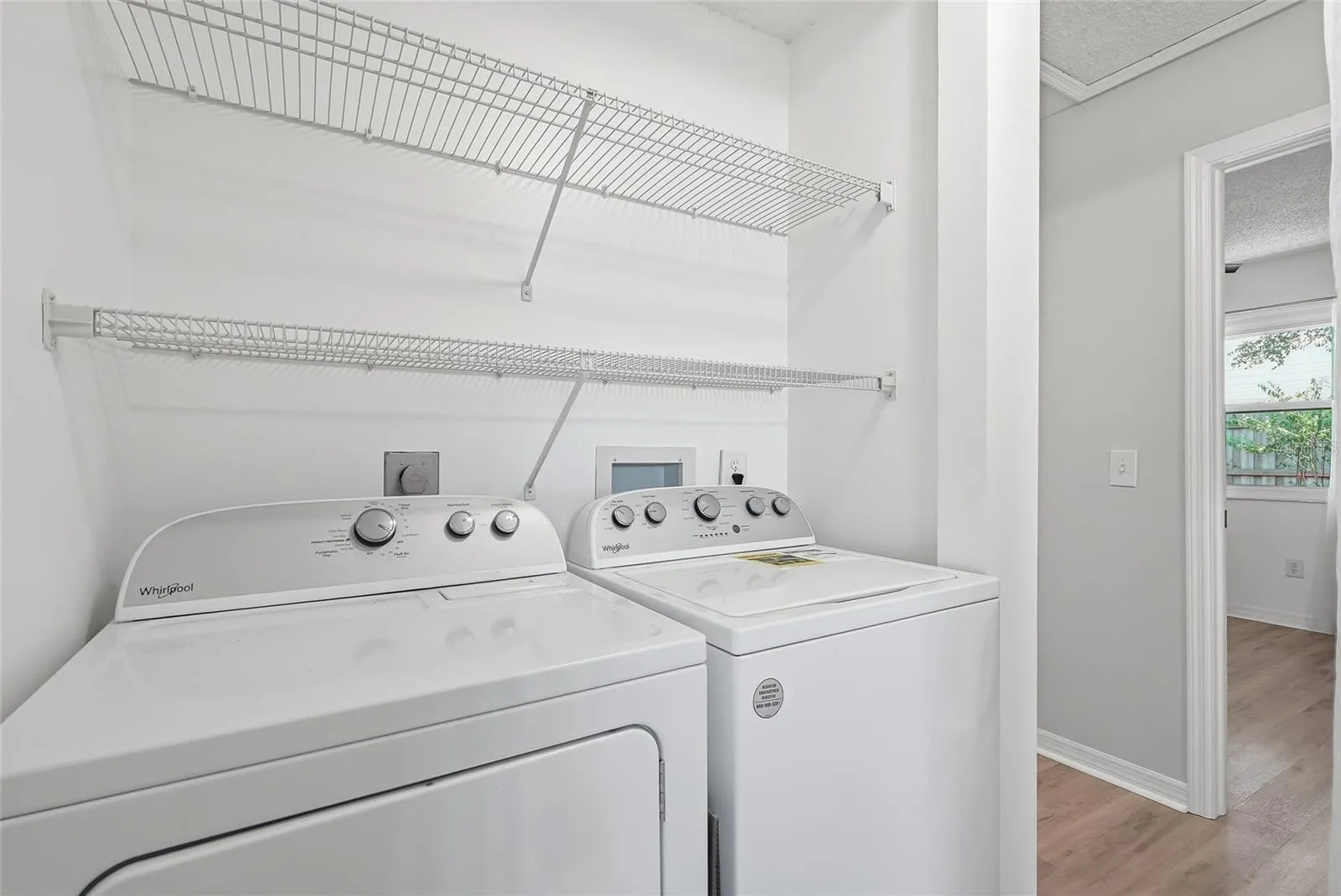 Inside laundry with newer full size washer and dryer.