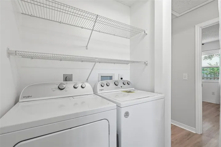 Inside laundry with newer full size washer and dryer.