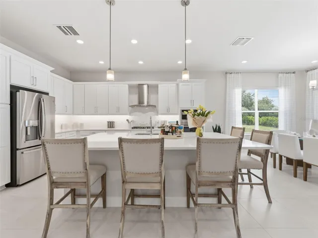 This kitchen features an oversized island with casual seating.