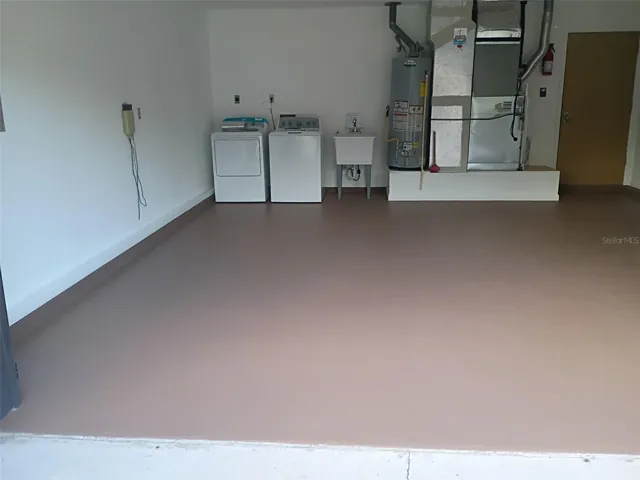 Garage with new washer, dryer, and laundry tub