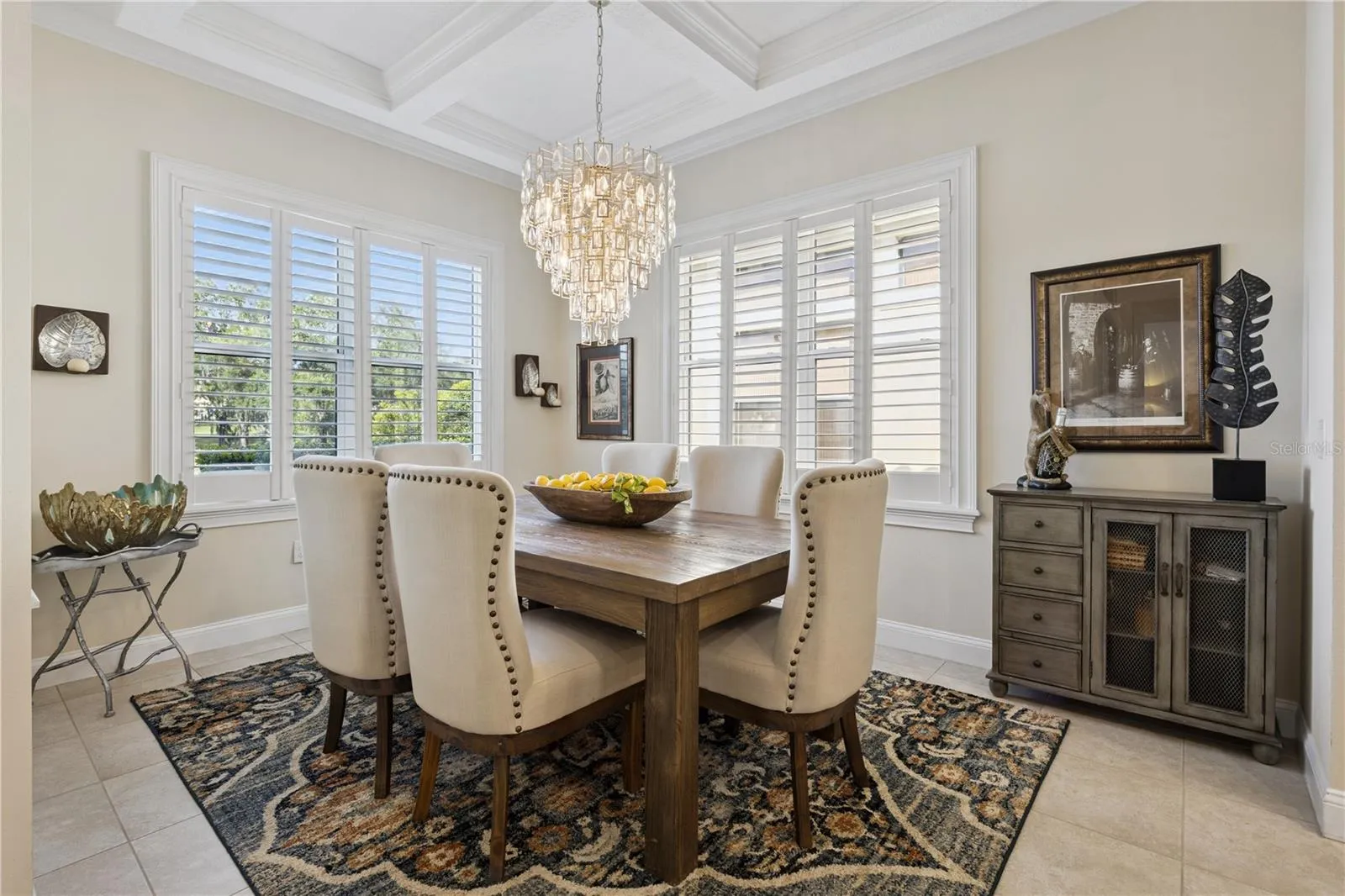 Stunning Dining room with designer light fixture and tray ceiling.