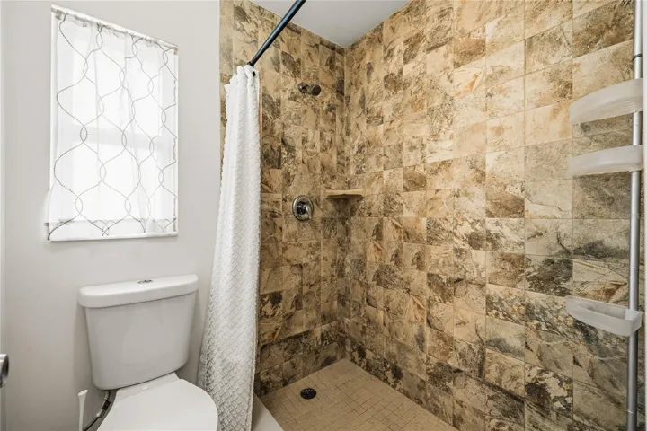 Renovated Step-in Primary shower with floor-to-ceiling shower surround