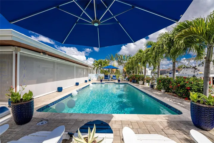 Designed for easy living, the home's impact glass windows and sliders, Bahama shutters, and Kevlar storm screens bring lasting peace of mind through every season.