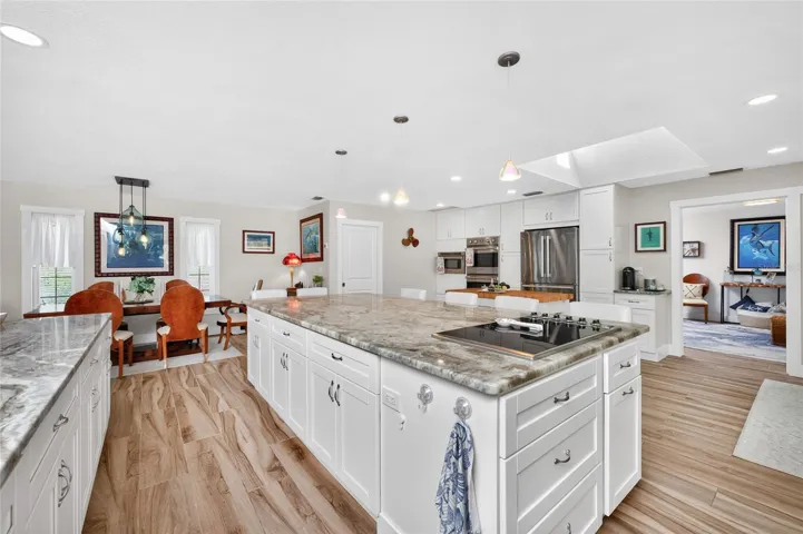 The island commands the room, anchored by a built-in Viking cooktop.