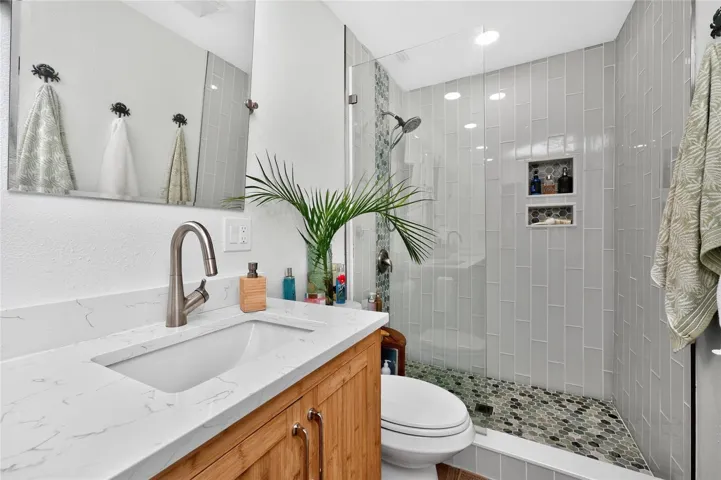 Bamboo, marbled quartz, a frameless glass shower worth lingering — every finish dialed in.