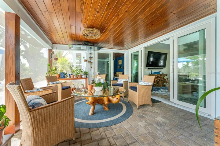 This resin composite plank ceiling brings warmth and weatherproof elegance .