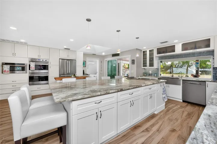 Custom wall cabinetry frames a chef's dream lineup — dual 30