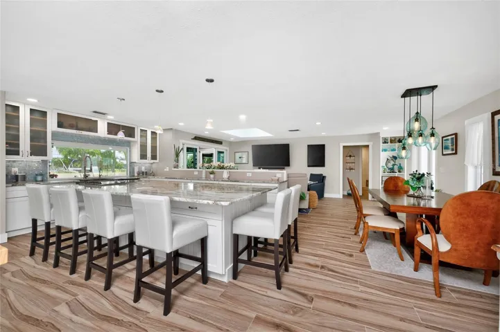 Bruck pendants and skylights pour light over every detail of this  open-concept design, where form, function, and finish come together in perfect balance.