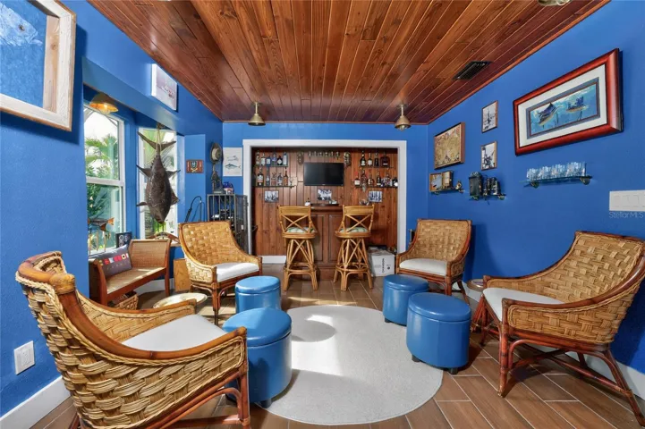 Reclaimed nautical lights catch the warmth of rich wood-plank porcelain tile floor — an ode to authentic maritime craftsmanship