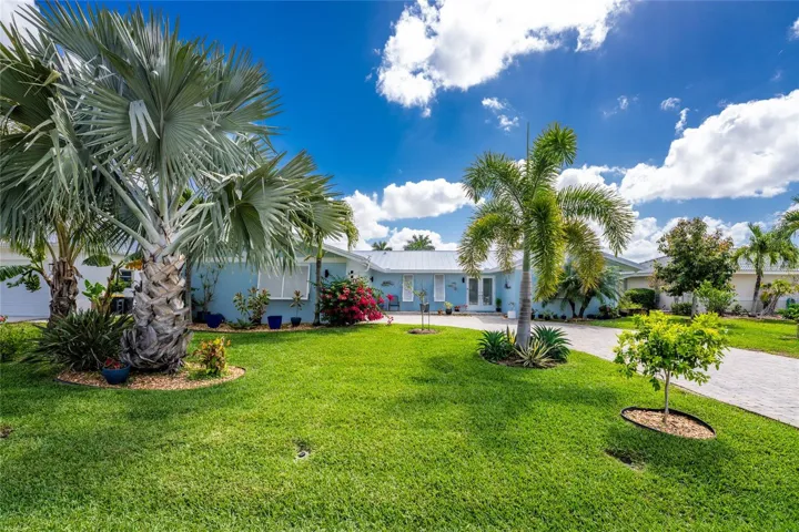 Mid-century charm meets lush grounds with a wide variety of tropical palms, flowering and fruit bearing tropical  trees. Blue and Mahoi Bananas, Meyer Lemons, Key Lime, Peach, Tangelo , Tangerine, Avocado