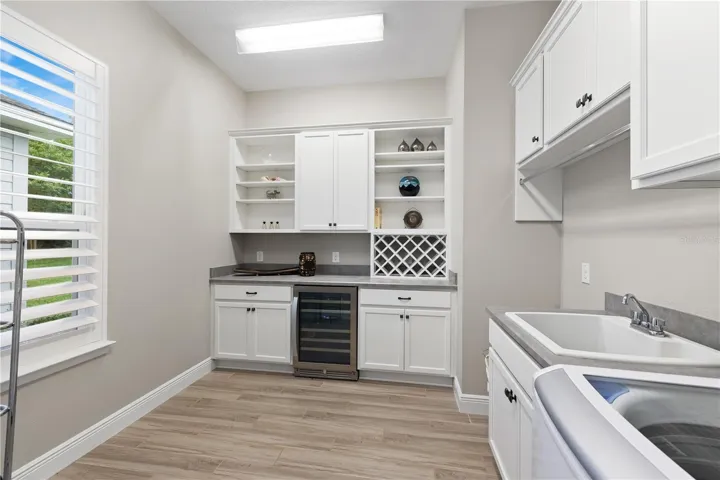 Fancy laundry room with wine cooler