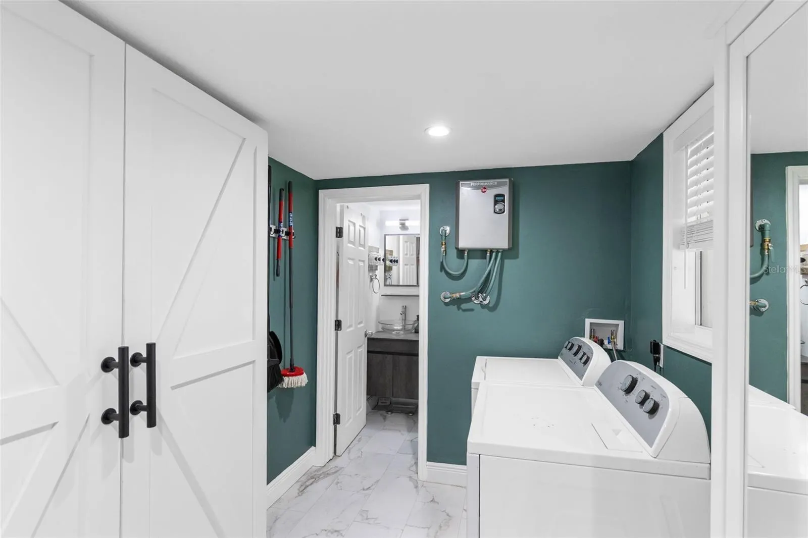 Oversized Laundry room with storage cabinets