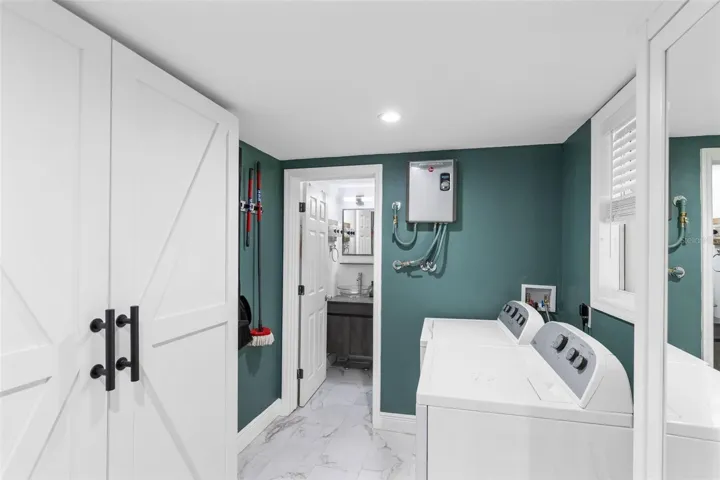 Oversized Laundry room with storage cabinets