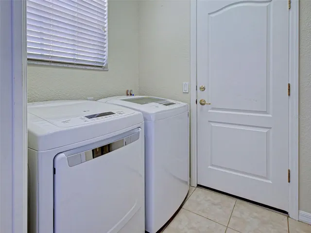 laundry room with a utility sink and storage closet/pantry
