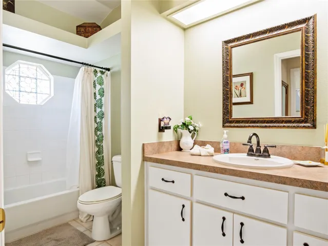Guest bathroom with combination shower/tub.