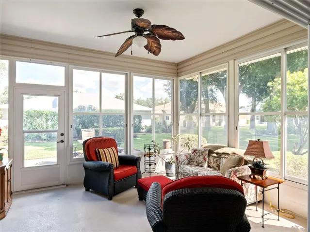Comfortable throughout the year, this enclosed lanai offers quiet views of back garden.