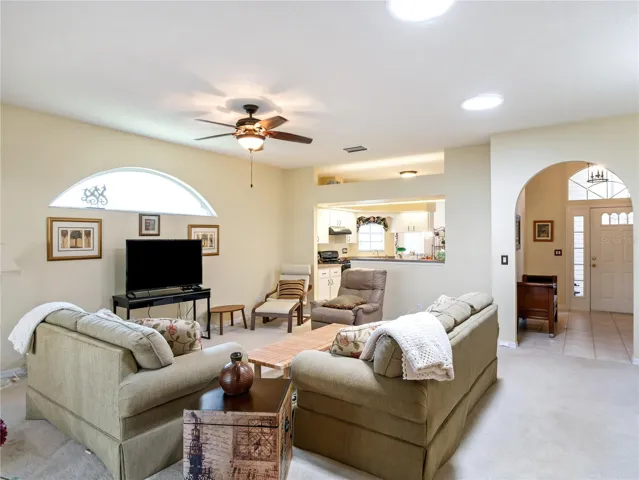 Kitchen opens to living area with adjacent dining space.
