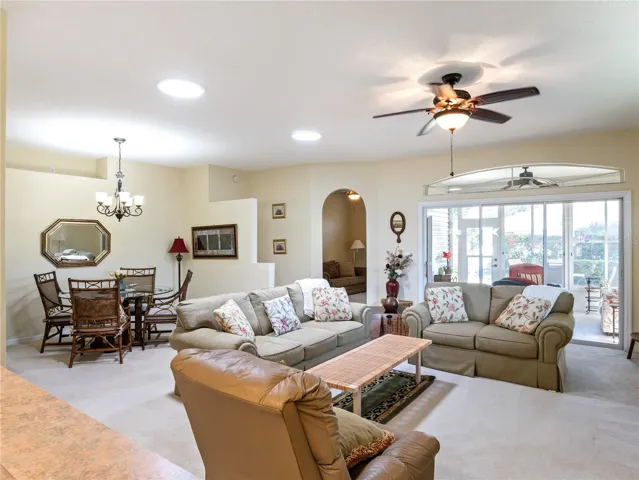 Combination living and dining area open to back covered porch through sliding glass doors.