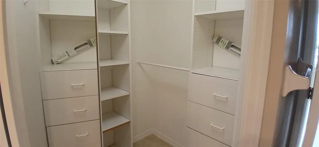 1 of 2 walk in closets in primary bedroom