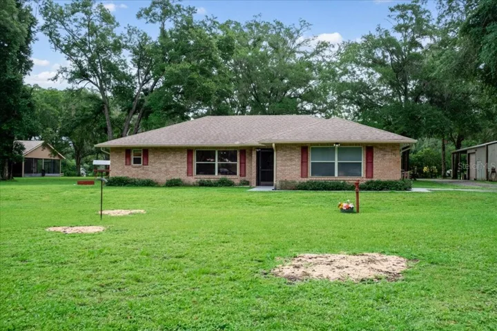 Front elevation of this single-story brick home situated on a spacious lot in Lake Helen the GEM of Forida