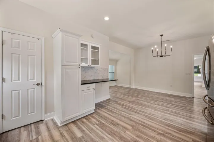 Kitchen with large open concept dining space and inside laundry closet