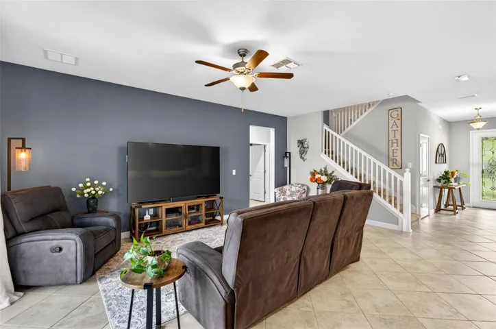 Large living area with foyer and stairwell leading to second floor
