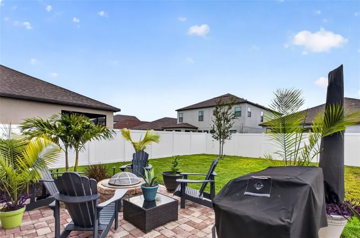 Extended pavered area with firepit.