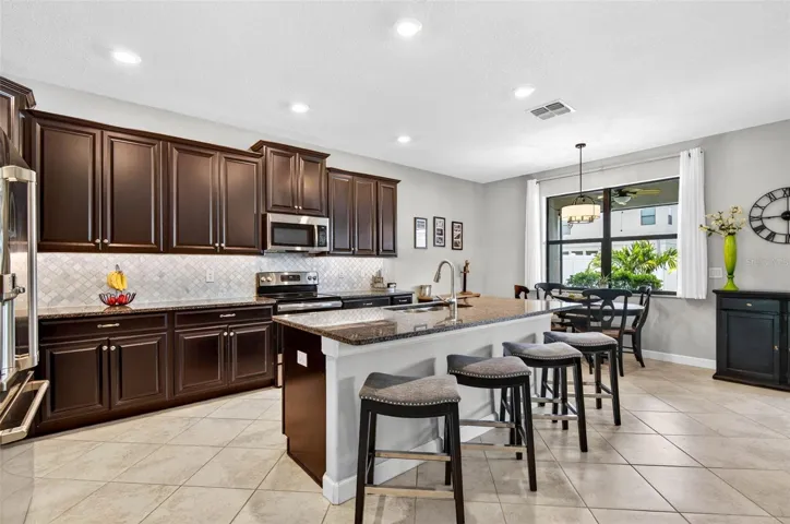 Kitchen with large island, granite countertops, 42