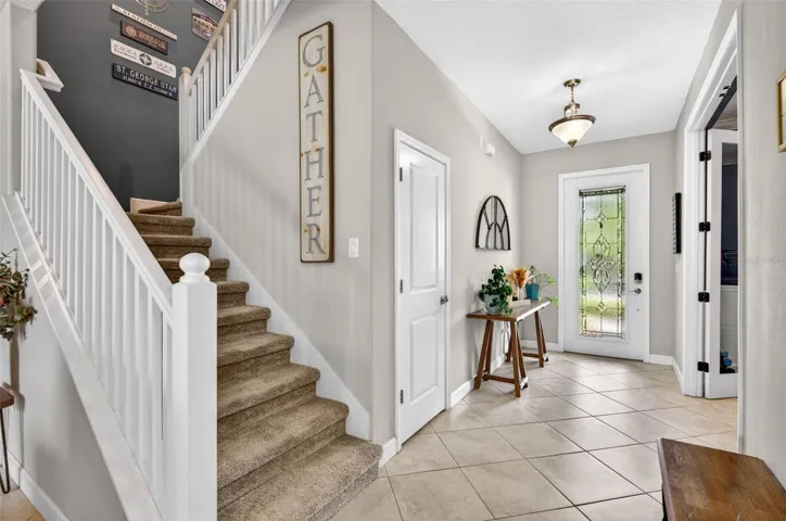 Foyer and decorative banister with stairs leading to second floor.