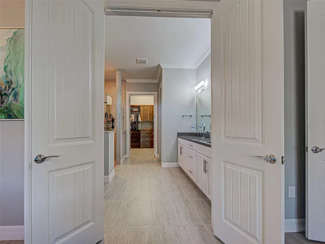Double solid doors leading to the en suite bathroom
