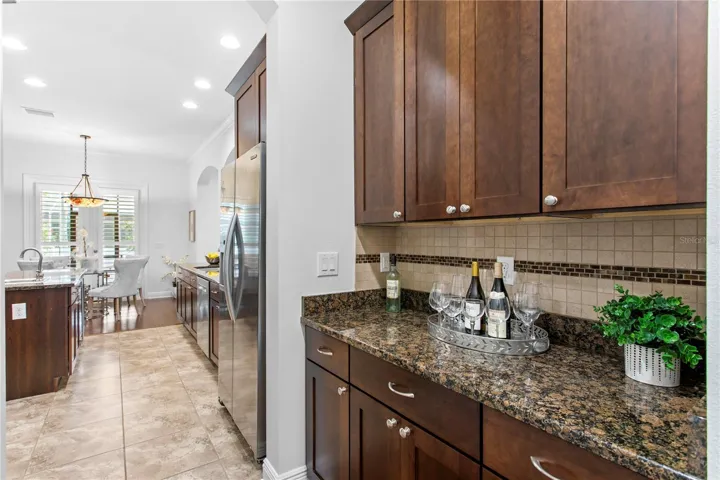 Conveniently positioned between the kitchen and dining room, the dry bar enhances both function and flow.