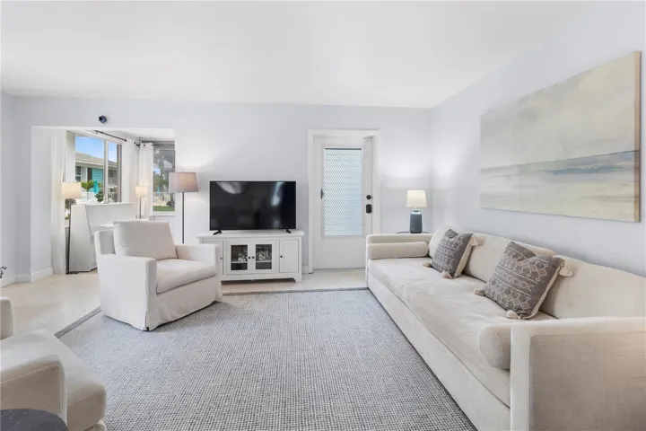 View of Front Entry Door in living room and sun room from the hallway