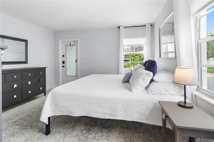 Primary Bedroom with back door exit (for safety) of the condo leading to private outdoor storage closet.