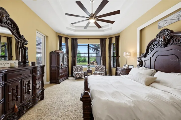 Primary bedroom with views of the pool, lake and preserve