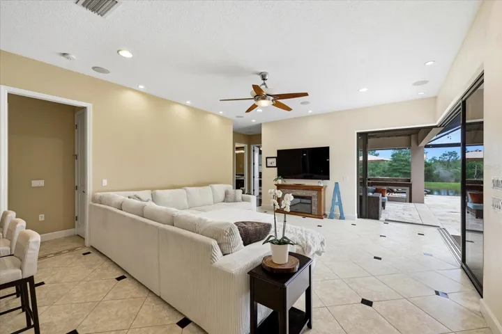 Family room off the kitchen with corner sliding doors opening up the space to the outdoor deck