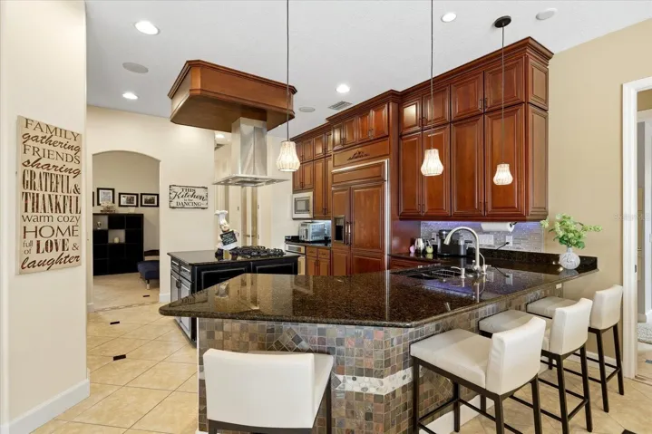Chef's kitchen with natural gas cooktop and integrated fridge