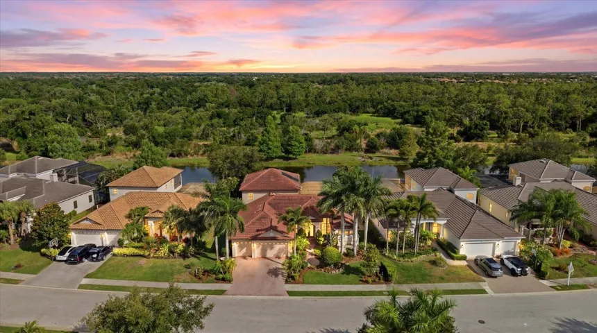 Aerial view of the home situated on the lake with preserve views