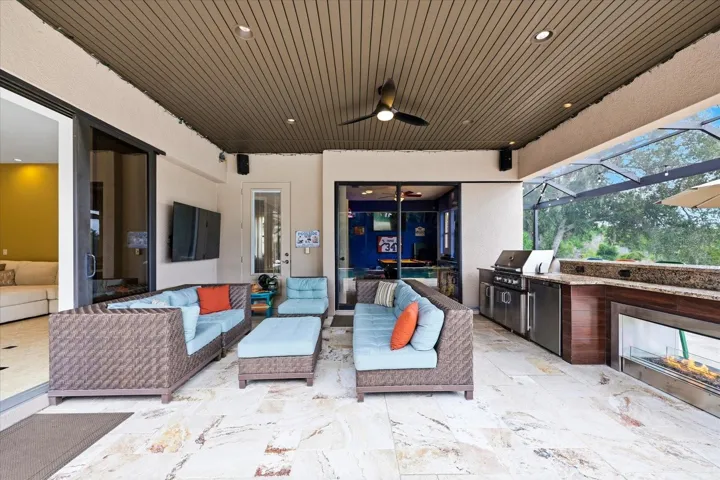 Gas fireplace and grill. Door to game room and pool bathroom