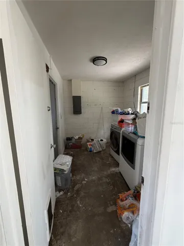 Laundry room with door to carport area