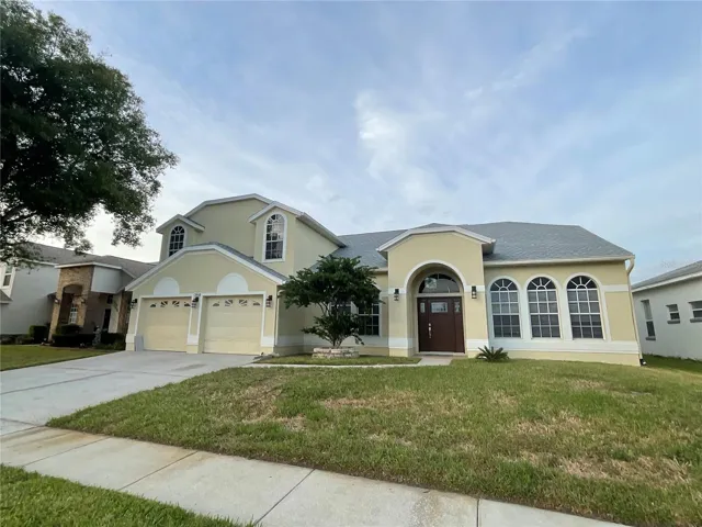 Front of 5 bedroom, 2.5 bathroom plus an office, 2 -car garage. POOL and Pond frontage