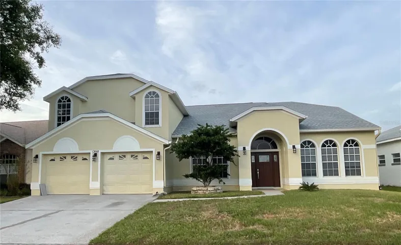 Front of 5 bedroom, 2.5 bathroom plus an office, 2 -car garage. POOL and Pond frontage