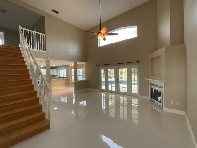 Family Room with gas fireplace, Pool/waterfront View, Wooden Staircase