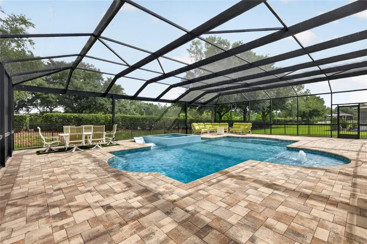 Huge paver pool deck 48' x 55' with dining and seating areas ~