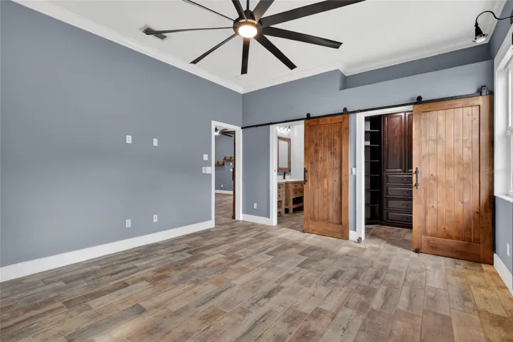 Sliding knotty Alderwood doors to the ensuite bathroom and walk-in closet ~
