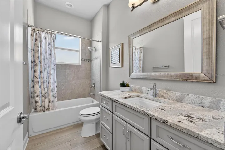 Guest Bathroom nicely renovated with quartz counter tops