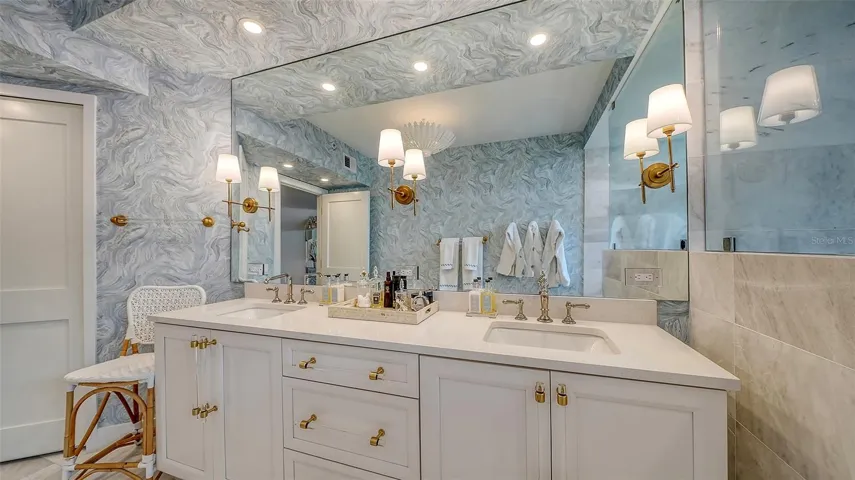The beautiful renovation is displayed with the custom sconces fixtures cabinetry throughout