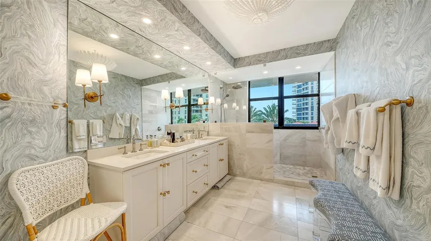 Luxurious primary bathroom creates  soft creamy finishes that compliment the dual vanity w/ ample storage ~ spa like aura