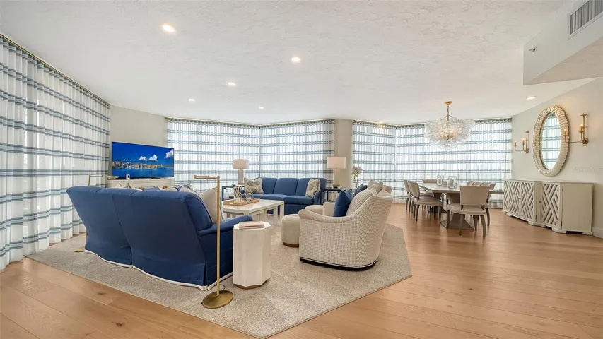 The custom sheers create privacy when needed being the walls of windows exude natural light throughout the home